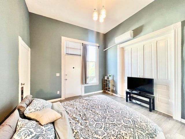 interior space featuring light hardwood / wood-style floors and a wall unit AC