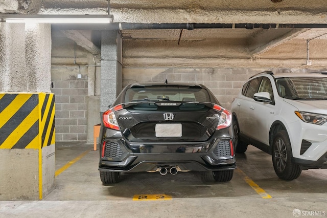 parking garage featuring concrete block wall