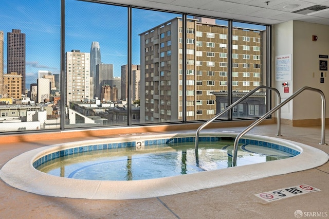 view of pool featuring a view of city and a community hot tub