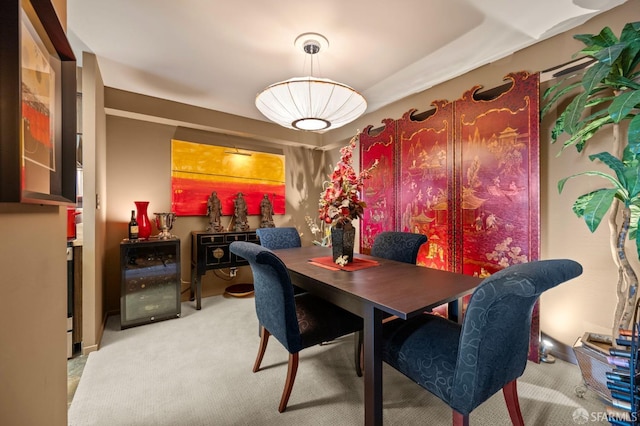 carpeted dining space with wine cooler