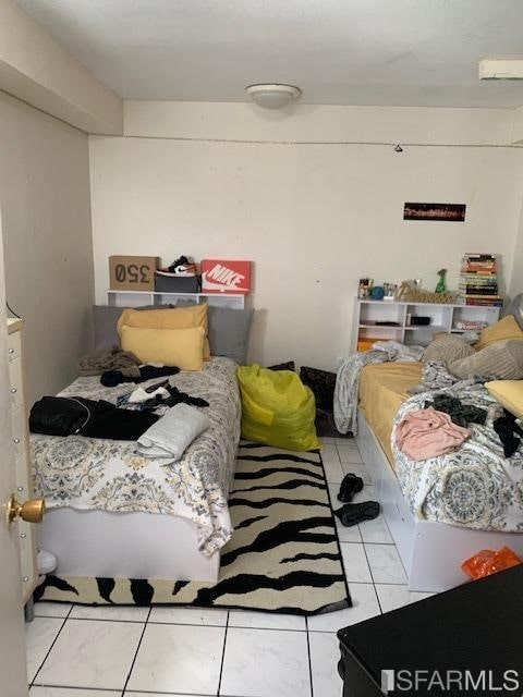 bedroom featuring light tile patterned flooring