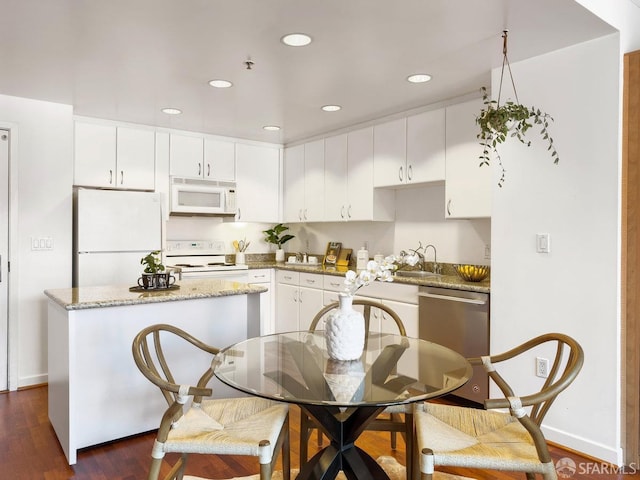 250 King St Unit 528, San Francisco, CA 94107 - kitchen with a sink, white appliances, dark wood-type flooring, and white cabinets
