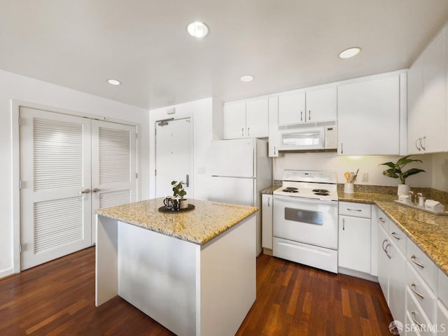 250 King St Unit 528, San Francisco, CA 94107 - kitchen featuring white cabinetry, white appliances, dark wood-type flooring, and a center island