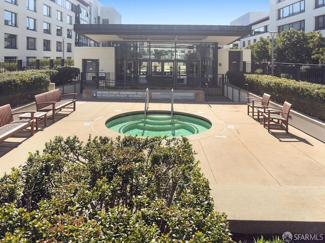 250 King St Unit 528, San Francisco, CA 94107 - view of swimming pool with a community hot tub and fence