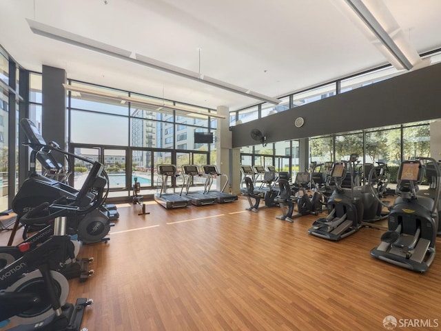 250 King St Unit 528, San Francisco, CA 94107 - gym featuring a wall of windows and wood finished floors
