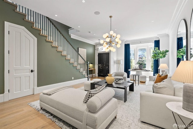 living area with stairway, a notable chandelier, wood finished floors, and ornamental molding