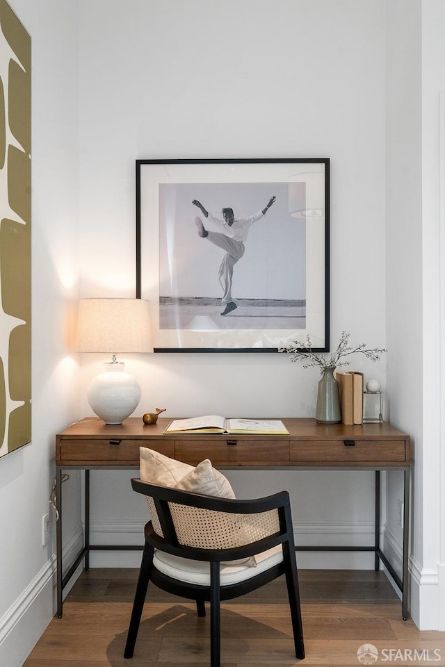 home office featuring baseboards and wood finished floors