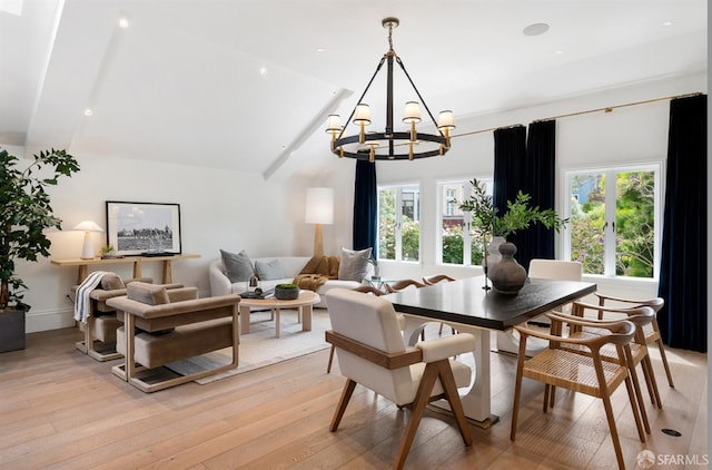 dining area with beamed ceiling, a notable chandelier, light wood-type flooring, and a wealth of natural light