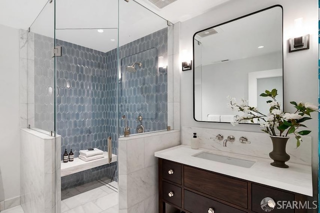 full bath with visible vents, marble finish floor, vanity, and a tile shower