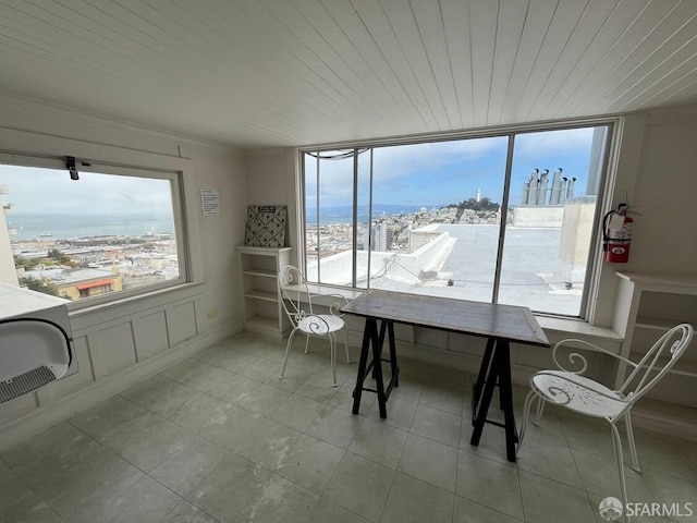 sunroom / solarium with a water view and wooden ceiling