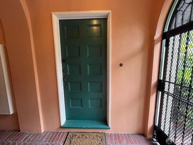 view of exterior entry featuring stucco siding