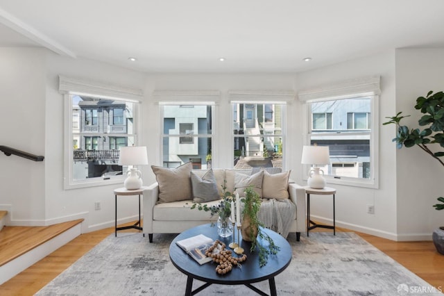 living area with recessed lighting, wood finished floors, and baseboards