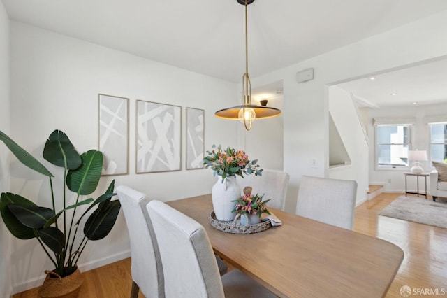 dining area featuring baseboards and wood finished floors