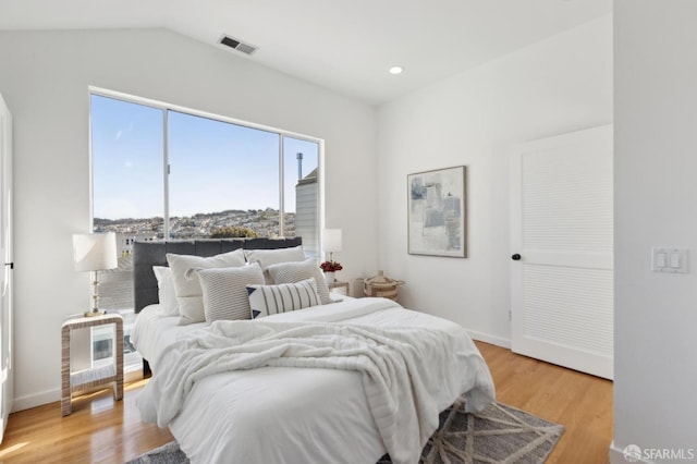 bedroom with visible vents, baseboards, vaulted ceiling, recessed lighting, and light wood-style floors