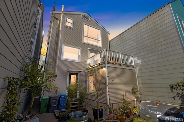 rear view of property featuring a balcony