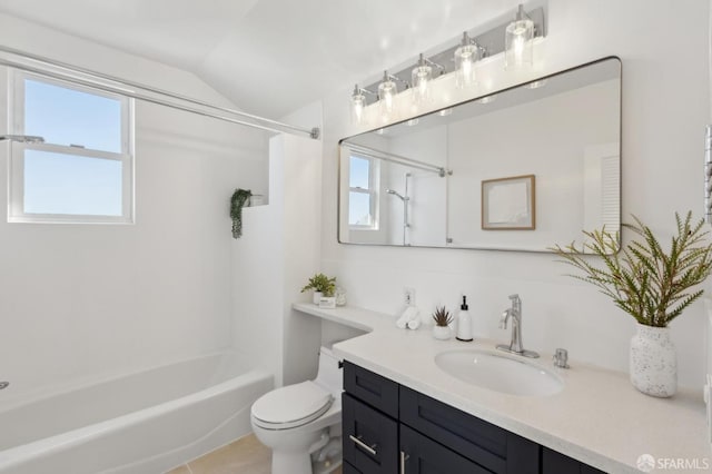 bathroom featuring toilet, vanity, bathing tub / shower combination, and vaulted ceiling