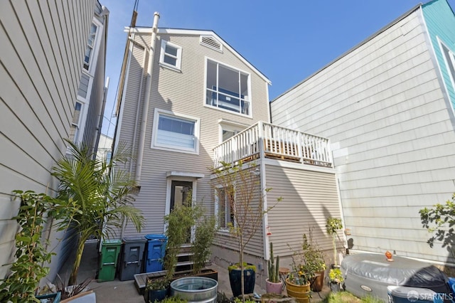 rear view of house with a balcony