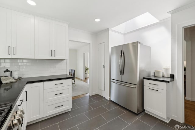 1944 15th Ave, San Francisco, CA 94116 - kitchen with appliances with stainless steel finishes, dark countertops, crown molding, tasteful backsplash, and white cabinets