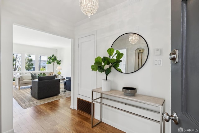 1944 15th Ave, San Francisco, CA 94116 - foyer with a chandelier, wood finished floors, and ornamental molding