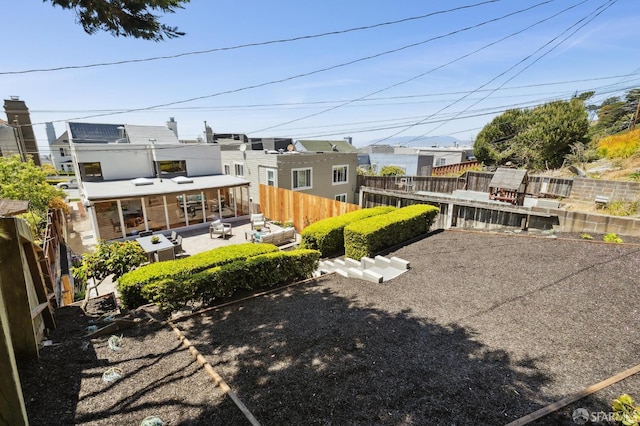 1944 15th Ave, San Francisco, CA 94116 - fenced backyard with an outdoor hangout area, a patio, and a residential view