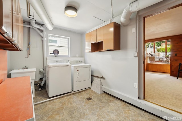 1944 15th Ave, San Francisco, CA 94116 - washroom with separate washer and dryer, light stone finish floors, cabinet space, and baseboards