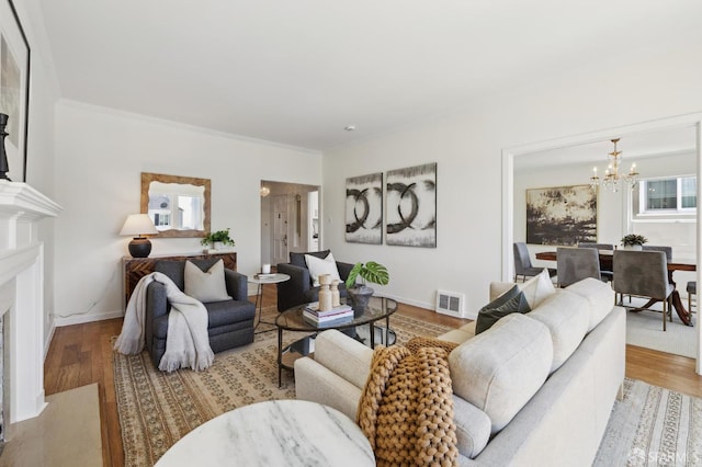 1944 15th Ave, San Francisco, CA 94116 - living room with a chandelier, wood finished floors, crown molding, and a fireplace with flush hearth