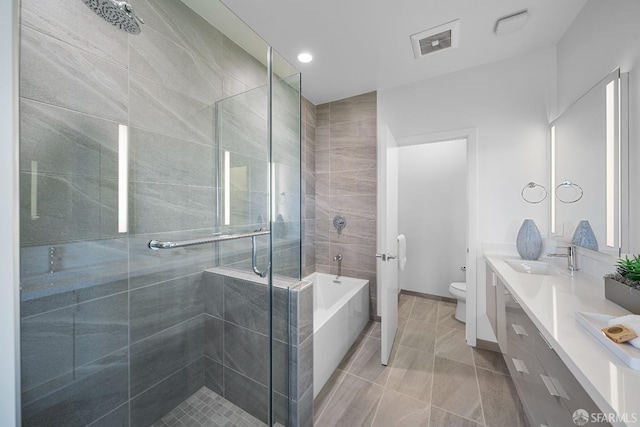 full bathroom featuring tile patterned floors, toilet, vanity, and plus walk in shower