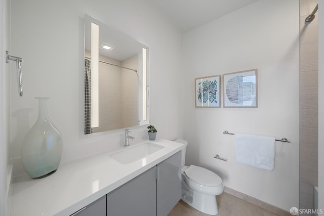 bathroom featuring vanity, walk in shower, and toilet