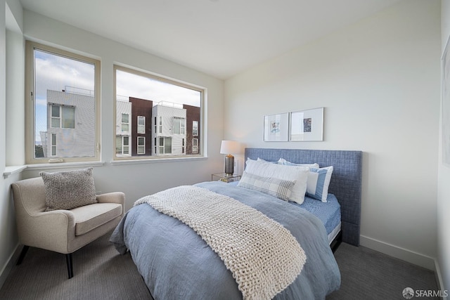 bedroom featuring dark carpet