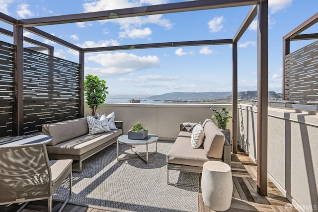 view of patio / terrace with a lanai, a mountain view, and an outdoor living space