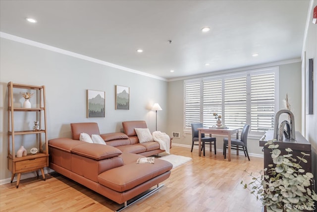 living room featuring light wood-type flooring and ornamental molding