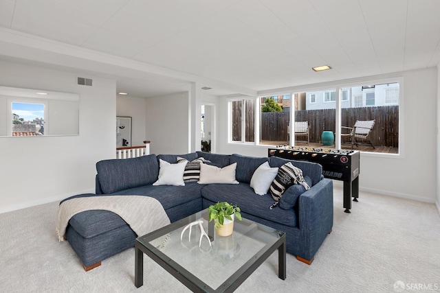 living room featuring plenty of natural light and light colored carpet