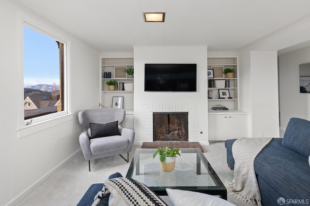 carpeted living room with a fireplace and built in shelves