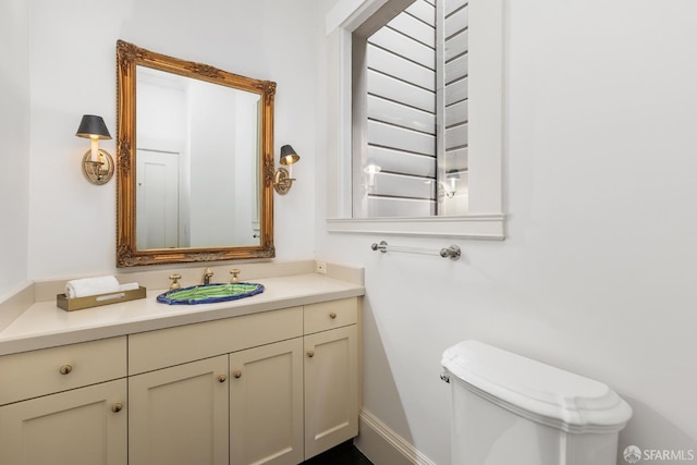 bathroom featuring vanity and toilet