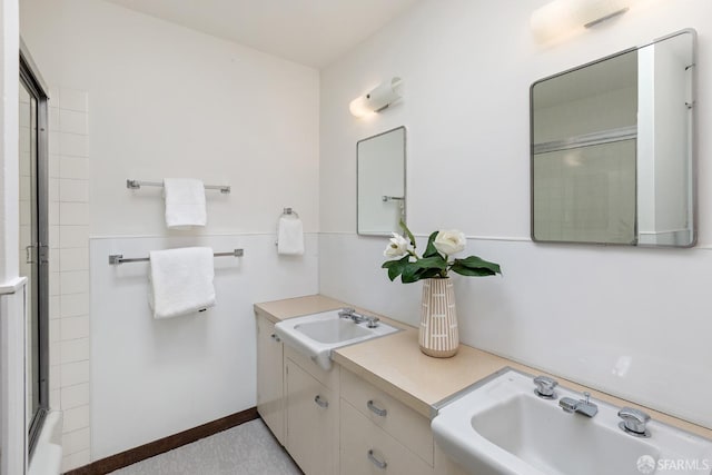 bathroom featuring vanity and combined bath / shower with glass door