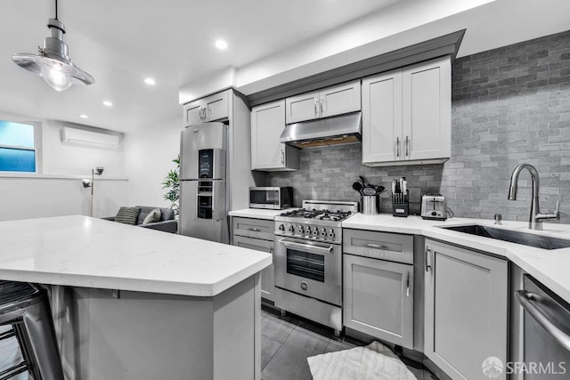 3014 Pine St Unit A, San Francisco, CA 94115 - kitchen featuring under cabinet range hood, appliances with stainless steel finishes, a sink, gray cabinets, and decorative backsplash