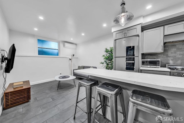 3014 Pine St Unit A, San Francisco, CA 94115 - kitchen featuring refrigerator, stainless steel microwave, a kitchen bar, custom exhaust hood, and decorative backsplash