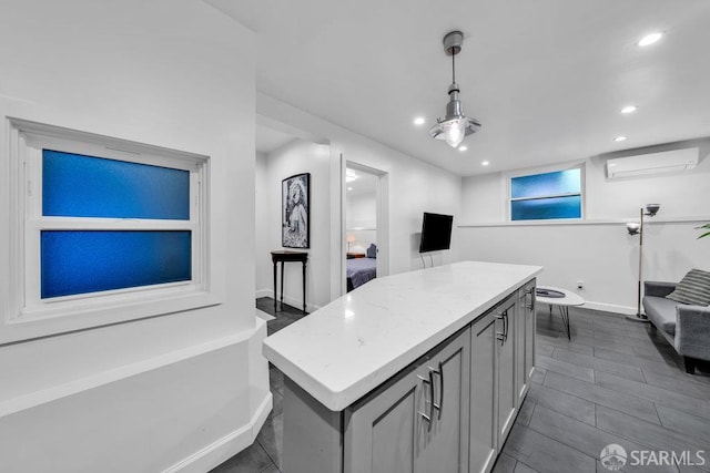 3014 Pine St Unit A, San Francisco, CA 94115 - kitchen with a wall mounted air conditioner, a kitchen island, recessed lighting, baseboards, and light countertops