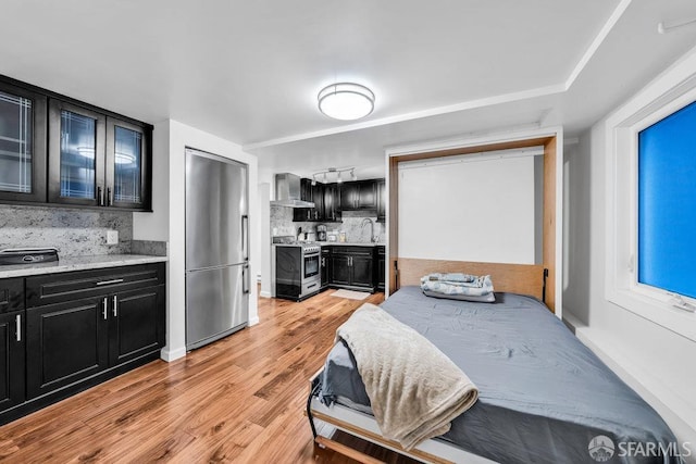 3014 Pine St Unit A, San Francisco, CA 94115 - bedroom with stainless steel built in fridge, light wood-style floors, and a sink