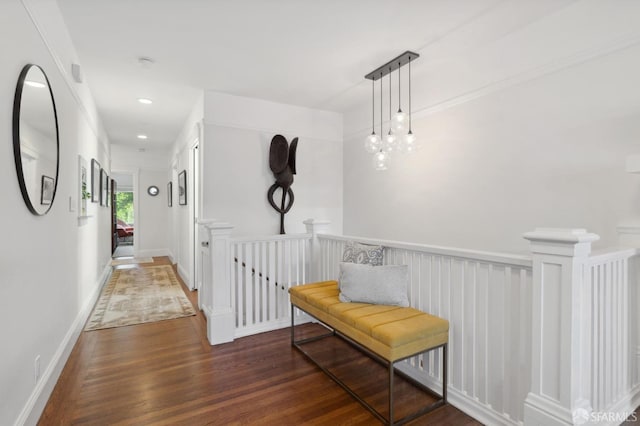 hallway with dark wood-style floors, an upstairs landing, baseboards, and recessed lighting