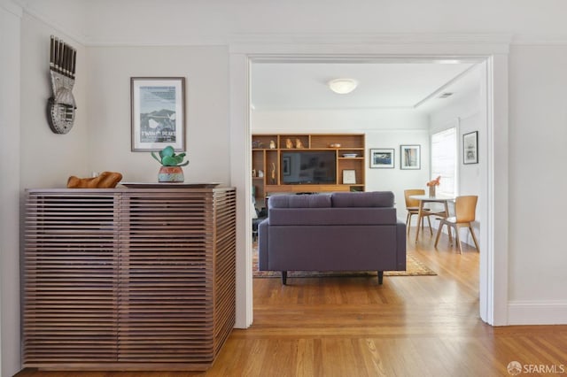 living room with light wood finished floors and baseboards