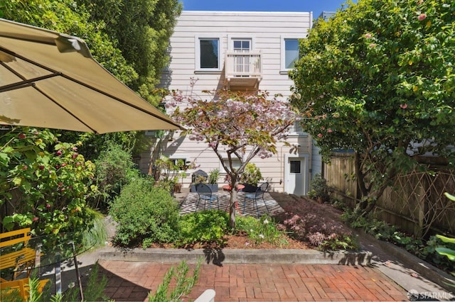 back of house featuring a patio area and fence
