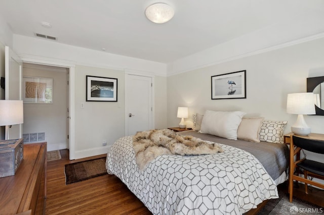 bedroom featuring dark wood-style floors and baseboards