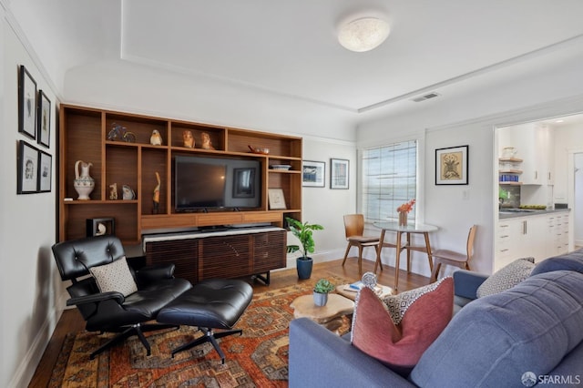 living area featuring baseboards and wood finished floors