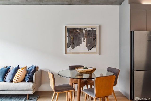 dining space with light hardwood / wood-style floors