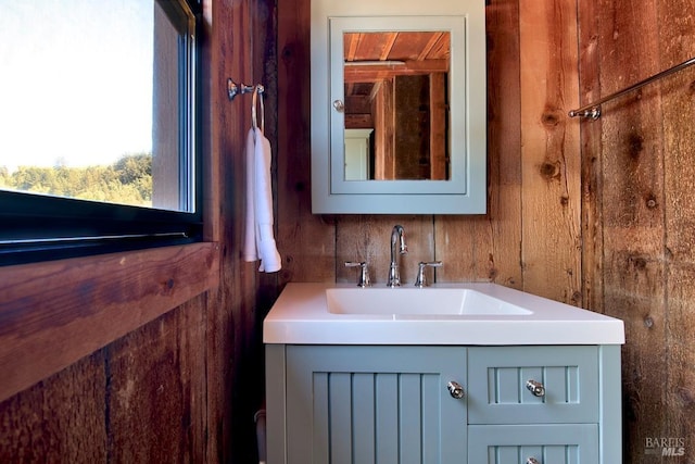 bathroom featuring wood walls and vanity