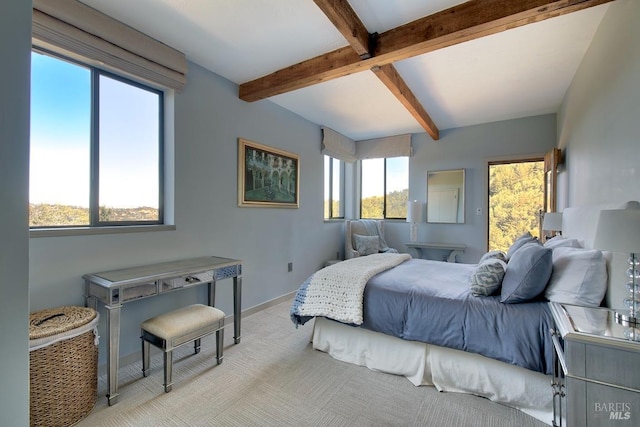 carpeted bedroom with beamed ceiling