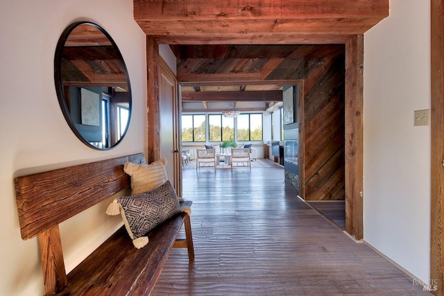 corridor featuring hardwood / wood-style flooring, wood ceiling, and beamed ceiling