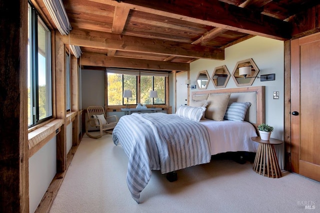 bedroom with beamed ceiling, light colored carpet, and wooden ceiling