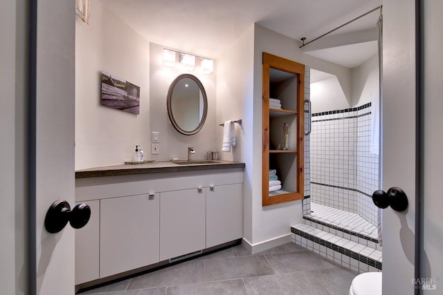 bathroom with vanity, toilet, and a shower